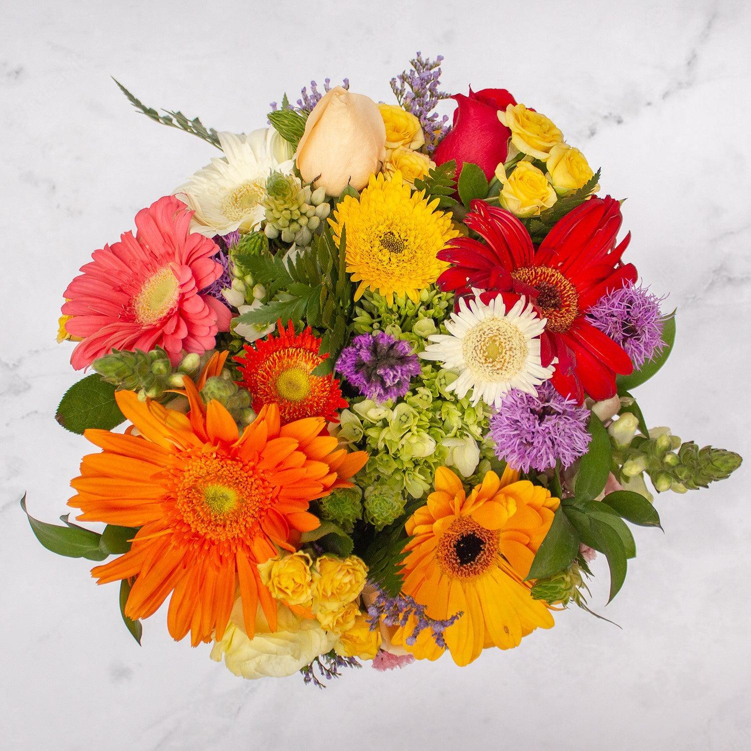 Arreglo floral de Gerberas Mix, Rosas, Boca de Dragón y Estate Morada -GI025-