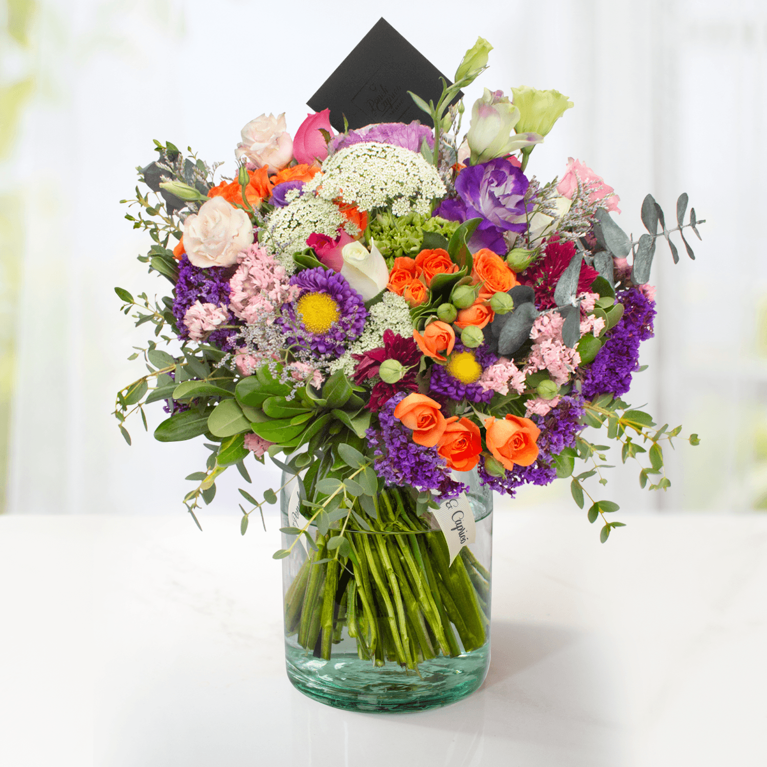Arreglo floral de Rosas Blancas, Rosas Fucsia, Lisianthus Pecoté Morado, Mini Rosa Naranja y Dólar Verde Preservado -GI0